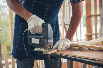 DIY craftsperson asian man working wood heap carpenter objects woodwork desk. Architect man hands use ruler measure hammer home improvement. Wooden builder carpenter repairing construction workshop