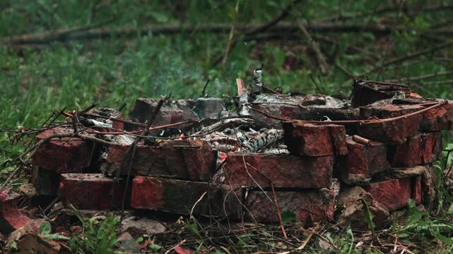 a smoldering campfire in the countryside. slow motion