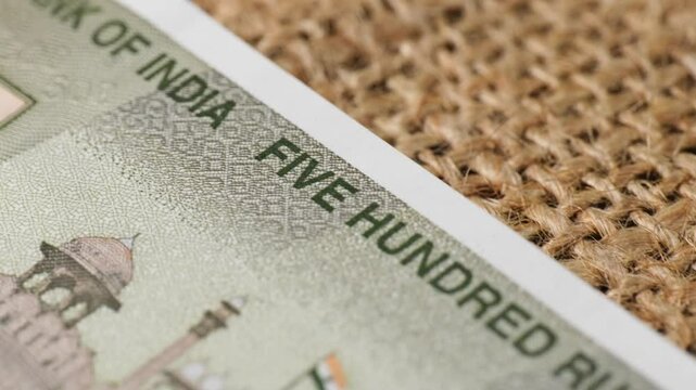 Indian currency of 500rs note in jute cloth with macro details, five hundred rupee text with national flag and red fort. close up shot, push in shot, 4k.