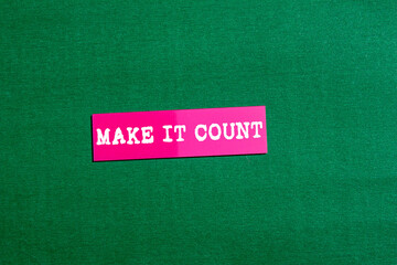 Make it count message written on pink paper sticker on green background. Conceptual make it count symbol. Copy space.