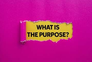 What is the purpose message written on ripped torn pink paper on yellow background. Conceptual what is the purpose symbol. Copy space.