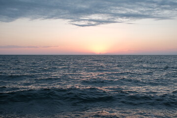 black sea water. dark sea water at sunset before a thunderstorm. black natural background. black...
