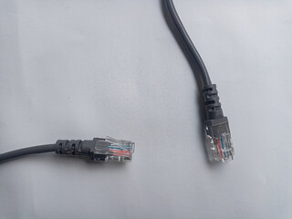 A coil of an Internet network cable for data transmission on a white background. Patch cord for LAN...