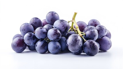 A cluster of fresh concord grapes with water droplets on a white background in a studio setting