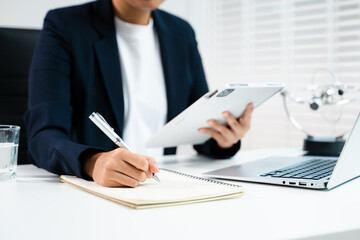 Businesswoman hand working digital marketing media in virtual screen with mobile phone and modern compute in office