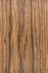 background is made of old  dark brown wood. an old board. the texture of a rustic table. american valnut, a place for a text or object. view from above. the effect of aging, vertical