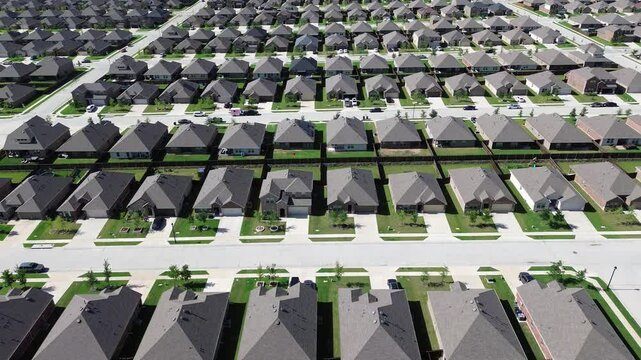 New development residential neighborhood in fast growing urban expansion Dallas Fort Worth metroplex area to surrounding countryside in Princeton, Texas, two story homes with young trees, flyover