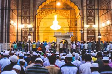 Holy Gathering: Muslim men, children and women gathered for evening Ramzan prayers during the Eid...