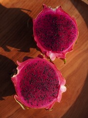 Ripe Red Dragon Fruit Halves on Wooden Surface