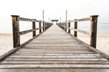 Fototapeta premium Long Wooden Pier Extending to Gazebo over Calm Water isolated on white background