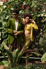 Obraz premium Young couple shares a romantic moment amid lush greenery in a vibrant greenhouse