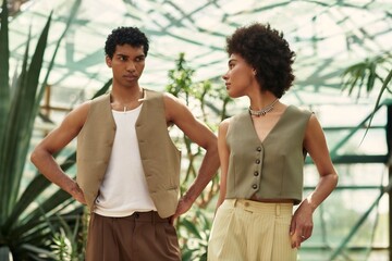 Young couple enjoying love and connection amidst lush greenery in a greenhouse setting