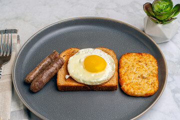 fried egg on toast  with breakfast links