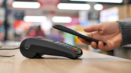 Close-up of contactless payment via smartphone at point of sale terminal in a store - Powered by Adobe