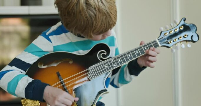 Caucasian Kid Play Mandolin at Home. European Boy Practice Music 4K 10-bit