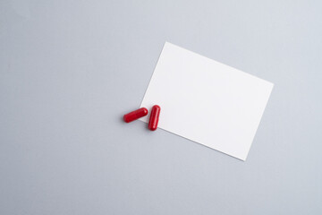 Pills with blank business card mockup. Taking vitamins or medicine. Healthcare, medicine, pharmacy,...