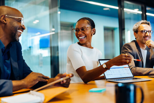 Diverse group discussing ideas in a bright and engaging office setting - Powered by Adobe