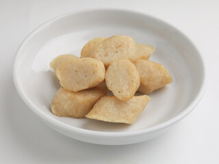 Fried rice cake on a plate, cut and served on white plate