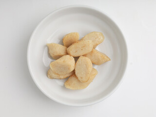 Fried rice cake on a plate, cut and served on white plate