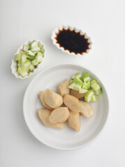 Fried rice cake on a plate, cut and served on white plate