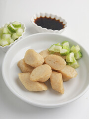 Fried rice cake on a plate, cut and served on white plate