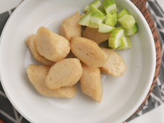 Fried rice cake on a plate, cut and served on white plate