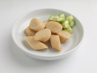 Fried rice cake on a plate, cut and served on white plate