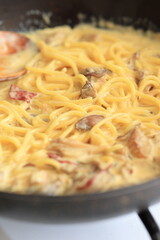 Creamy chicken mushroom spaghetti pasta in close-up