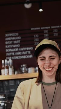 happy barista girl at the counter in the coffee