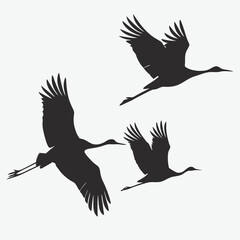 Fototapeta premium Silhouette illustration of graceful cranes in flight across a light grey sky