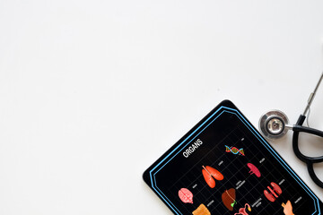 Tablet computer screen showing an  human organs diagram with a doctor's stethoscope nearby. Concept for modern medical,digital health records,telemedicine, online diagnosis,healthcare innovation.