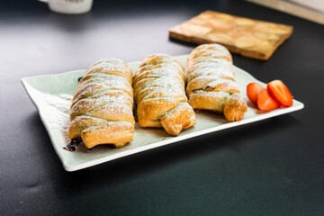 Puff pastry with chocolate and strawberries. Baking. Dessert. Dough.