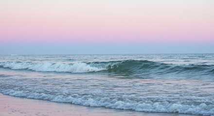 Obraz premium Pastel Pink and Blue Sunset Sky Over Ocean Waves and Sandy Beach