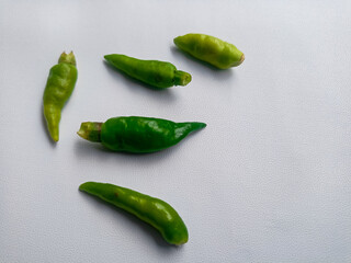 Green little hot chili for cooking isolated on with background.