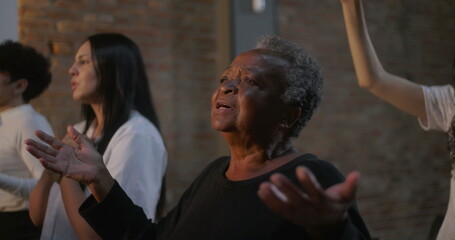 Women of different generations worshiping together, expressing faith and devotion in church, hands raised in prayerful unity, emotional and spiritual connection