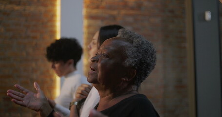 Women of different generations worshiping together, expressing faith and devotion in church, hands raised in prayerful unity, emotional and spiritual connection