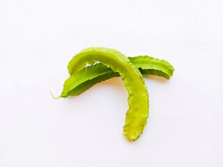 two winged beans isolated on a white background. a tropical legume with distinctive four-angled pods.