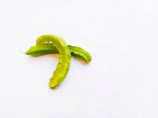 fresh winged beans on white background. two winged beans isolated on a white background. a tropical legume with distinctive four-angled pods.