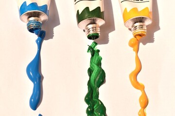 Open tubes of acrylic paint in various colors with spills. Vibrant composition capturing the...