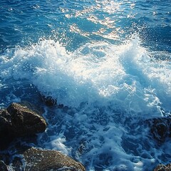 Ocean waves crashing on rocky shoreline coastal scene nature photography bright sunlight reflections aesthetic viewpoint concept