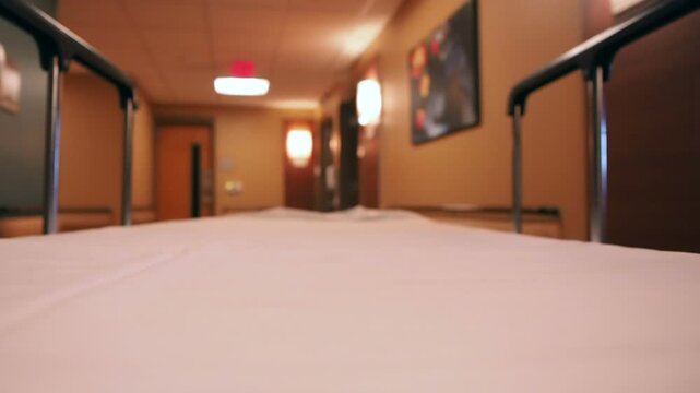 A hospital stretcher is being pushed down the hallway 