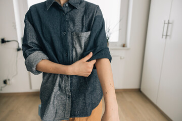 Young woman rolling up sleeves getting ready for morning routines