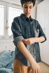 Girl rolling up sleeves getting ready in the morning