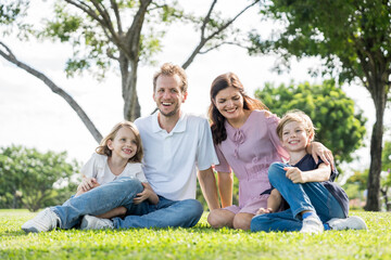 Fototapeta premium Happy family parent children having picnic outdoor activity. Enjoy happiness moment summer playing together including father mother son and daughter relaxing in the morning sunrise.