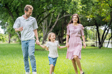 Fototapeta premium Happy family parent children having picnic outdoor activity. Enjoy happiness moment summer playing together including father mother son and daughter relaxing in the morning sunrise.