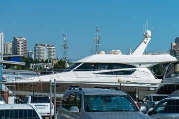 White boat in the parking lot of the resort town port.