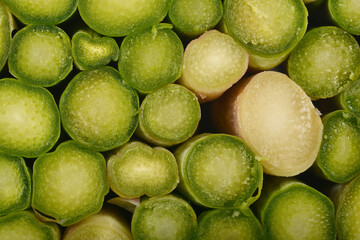 A close-up, bottom-up view shows a bundle of fresh, green asparagus spears tightly packed together