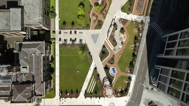 Wide overhead aerial video of City Quays Gardens in Belfast, Northern Ireland, UK on a bright and sunny day. Produced in 4K, 60FPS and with Rec709 color.