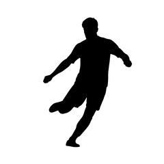 Silhouette of a soccer player kicking