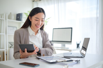 Professional accountant working with documents and laptop at desk.